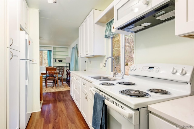 kitchen featuring a sink, electric range, white cabinets, and range hood