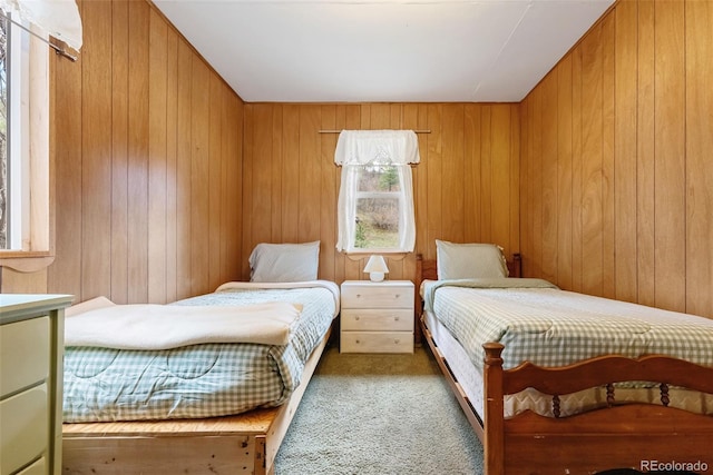 bedroom with carpet flooring and wood walls