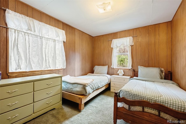 bedroom featuring wooden walls and carpet