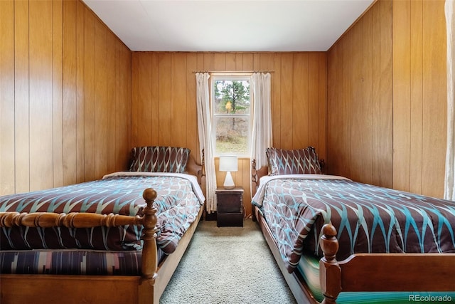 bedroom featuring wooden walls and carpet floors