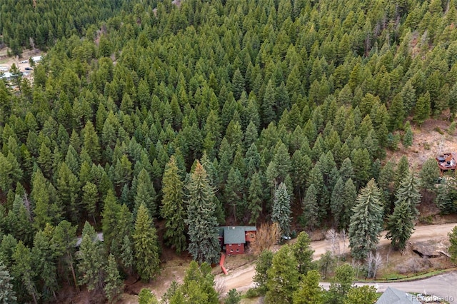 drone / aerial view featuring a view of trees