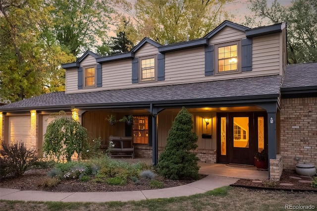 view of front of property with a porch and a garage