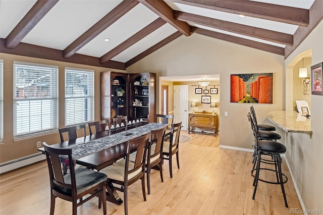 dining space featuring vaulted ceiling with beams, a baseboard radiator, and light hardwood / wood-style flooring