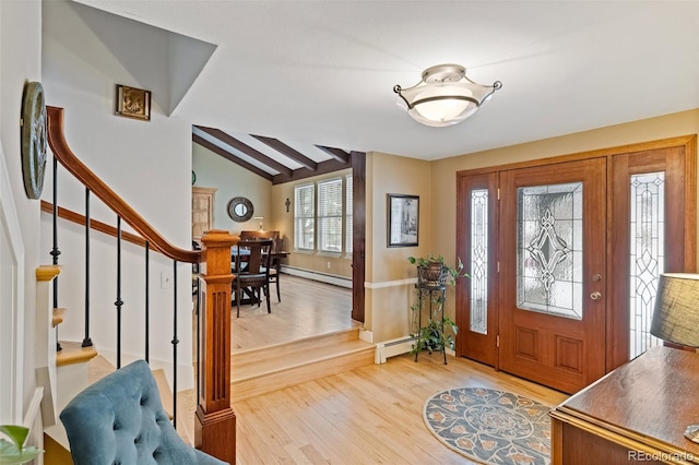 foyer featuring baseboard heating, vaulted ceiling with beams, and wood-type flooring