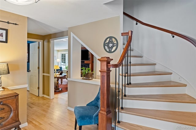 staircase with wood-type flooring