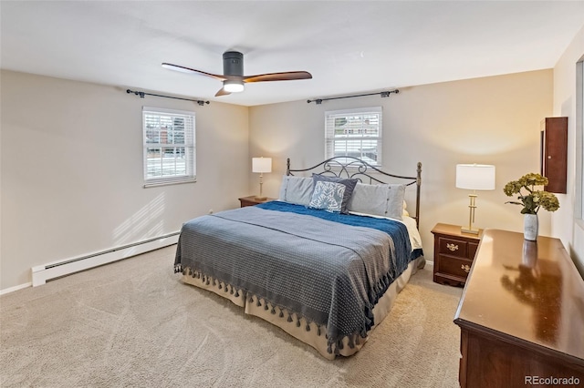 carpeted bedroom with a baseboard radiator and ceiling fan