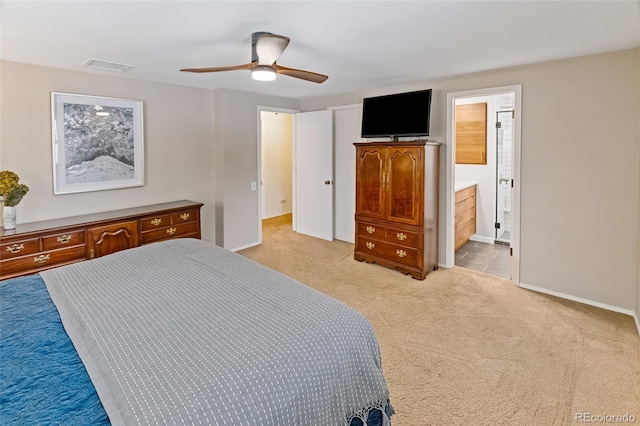 bedroom with ensuite bathroom, ceiling fan, and light carpet