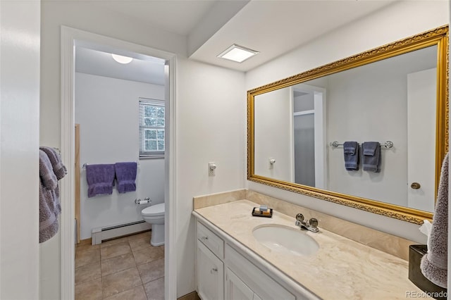 bathroom featuring tile patterned flooring, vanity, toilet, and a baseboard heating unit