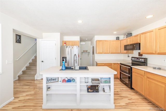 kitchen with a kitchen island with sink, sink, light brown cabinets, and black appliances