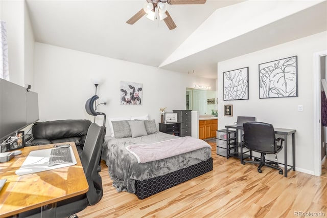 bedroom featuring vaulted ceiling, ensuite bath, ceiling fan, and light hardwood / wood-style floors