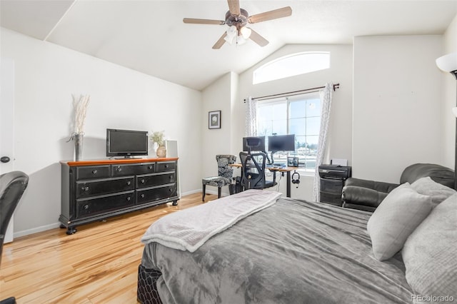 bedroom featuring hardwood / wood-style floors, vaulted ceiling, and ceiling fan