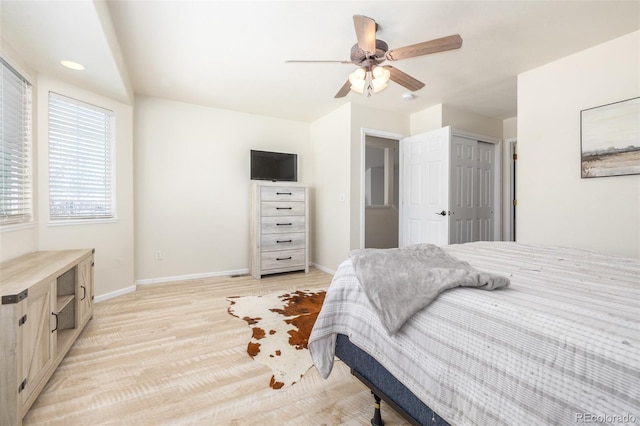 bedroom with light hardwood / wood-style floors and ceiling fan