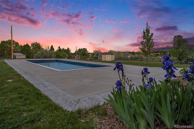 7624 Russell Ct, Arvada, CO 80007 - pool at dusk with an outdoor pool and a patio