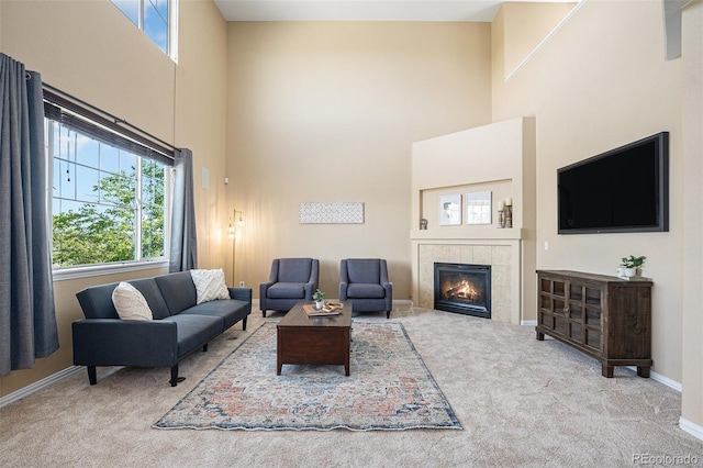 7624 Russell Ct, Arvada, CO 80007 - living area featuring carpet flooring, a high ceiling, a tiled fireplace, and baseboards