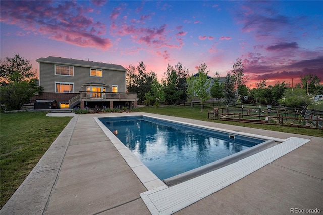7624 Russell Ct, Arvada, CO 80007 - pool at dusk featuring a wooden deck and an outdoor pool