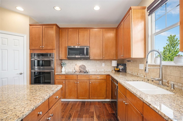 7624 Russell Ct, Arvada, CO 80007 - kitchen featuring a sink, stainless steel appliances, dark wood-style flooring, light stone counters, and recessed lighting