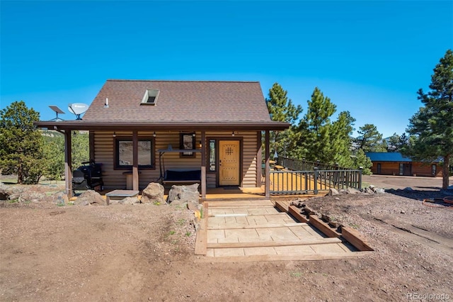 log cabin featuring a porch