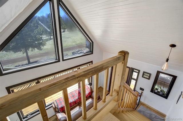 stairs featuring lofted ceiling and baseboards