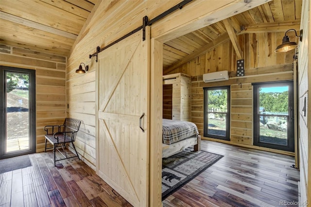 bedroom featuring a barn door, wood walls, wooden ceiling, multiple windows, and access to outside