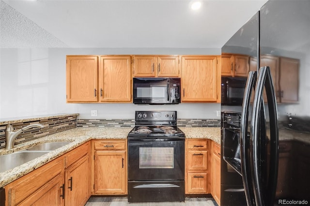 3090 W 107th Pl Unit F, Westminster, CO 80031 - kitchen featuring black appliances and light stone countertops