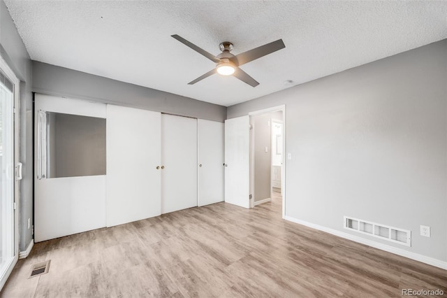 3090 W 107th Pl Unit F, Westminster, CO 80031 - unfurnished bedroom with wood finished floors, a textured ceiling, a closet, and a ceiling fan