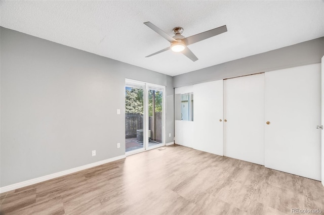 3090 W 107th Pl Unit F, Westminster, CO 80031 - unfurnished bedroom featuring access to outside, light wood-type flooring, ceiling fan, and a closet