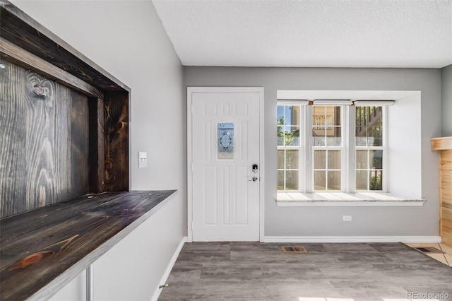 3090 W 107th Pl Unit F, Westminster, CO 80031 - foyer featuring wood finished floors and a textured ceiling