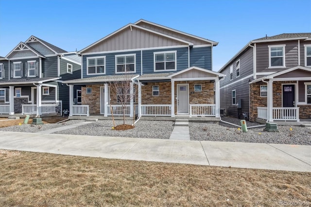 22384 E 6th Pl, Aurora, CO 80018 - view of front of house featuring board and batten siding, a porch, and stone siding