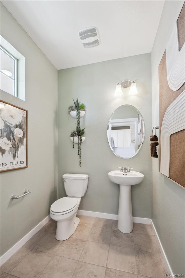 22384 E 6th Pl, Aurora, CO 80018 - bathroom featuring toilet, a sink, tile patterned floors, and baseboards