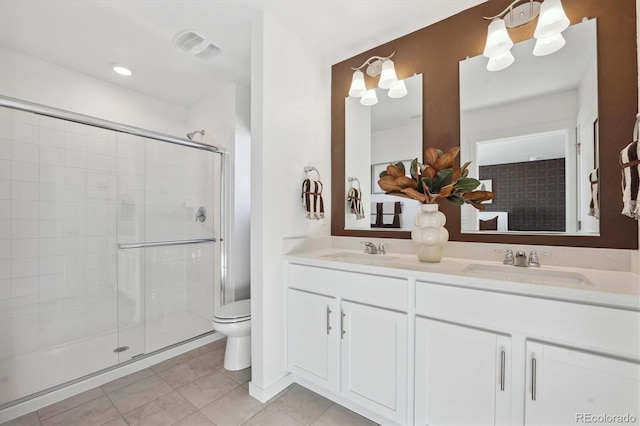 22384 E 6th Pl, Aurora, CO 80018 - bathroom featuring a shower stall, double vanity, toilet, and tile patterned floors