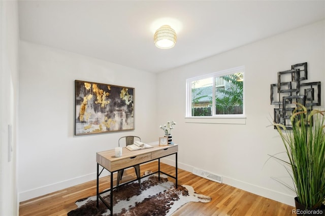 home office with hardwood / wood-style flooring