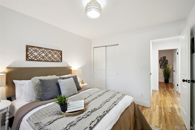 bedroom featuring light hardwood / wood-style floors and a closet