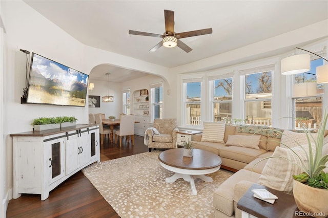 224 4th Ave, Severance, CO 80550 - living area with dark wood-style floors, ceiling fan, and arched walkways