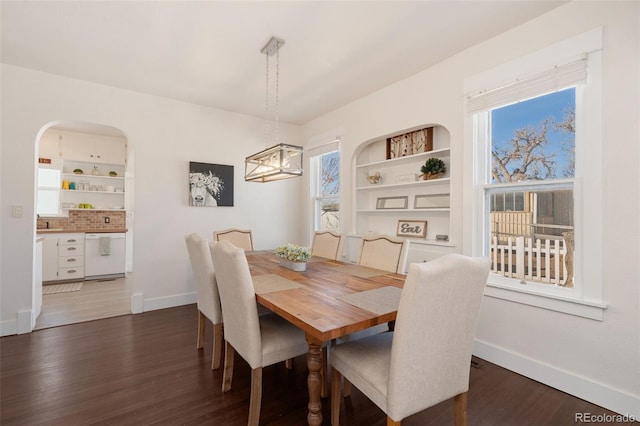224 4th Ave, Severance, CO 80550 - dining area featuring wood finished floors, built in features, and a chandelier