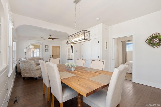 224 4th Ave, Severance, CO 80550 - dining area featuring dark wood finished floors, a ceiling fan, and arched walkways