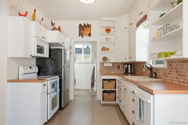 224 4th Ave, Severance, CO 80550 - kitchen with open shelves, white appliances, and white cabinetry