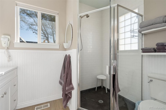 224 4th Ave, Severance, CO 80550 - bathroom with wainscoting, a stall shower, plenty of natural light, and vanity