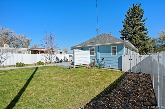 224 4th Ave, Severance, CO 80550 - back of house with a fenced backyard, a shingled roof, and a patio