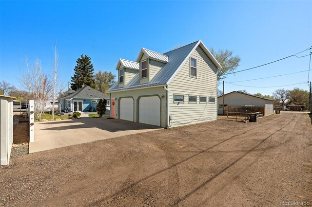 224 4th Ave, Severance, CO 80550 - view of side of home with a garage and a metal roof