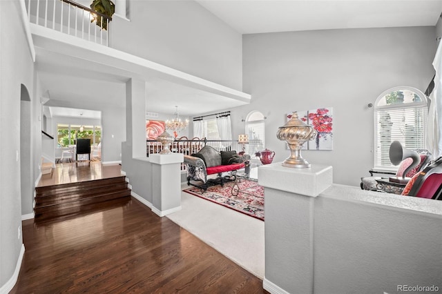 2062 Hyacinth Rd, Highlands Ranch, CO 80129 - living area with a high ceiling, a chandelier, wood finished floors, stairs, and healthy amount of natural light