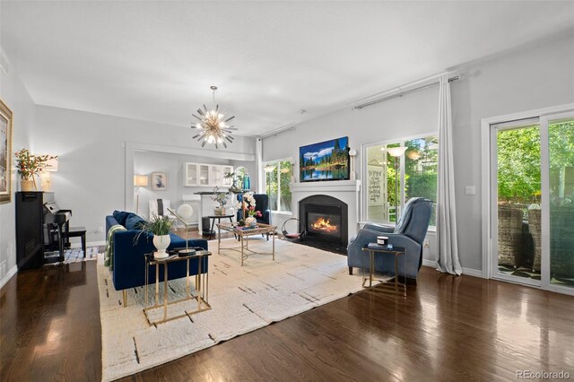 2062 Hyacinth Rd, Highlands Ranch, CO 80129 - living area with a fireplace with flush hearth, plenty of natural light, wood finished floors, and a chandelier