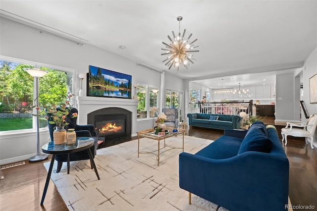 2062 Hyacinth Rd, Highlands Ranch, CO 80129 - living area with a chandelier, a fireplace with flush hearth, and wood finished floors