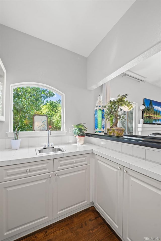 2062 Hyacinth Rd, Highlands Ranch, CO 80129 - kitchen with white cabinets, dark wood-style floors, and tile countertops