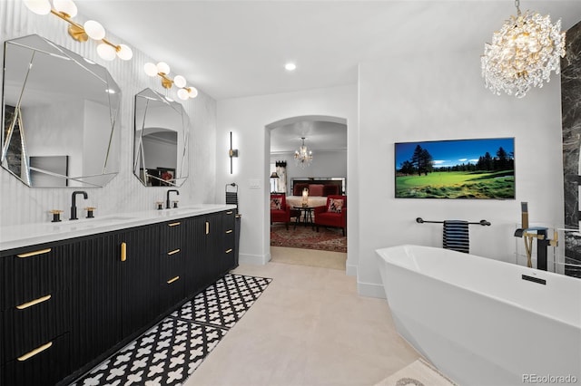 2062 Hyacinth Rd, Highlands Ranch, CO 80129 - ensuite bathroom with a chandelier, a freestanding bath, double vanity, and recessed lighting