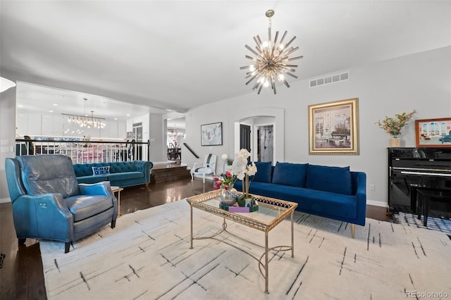 2062 Hyacinth Rd, Highlands Ranch, CO 80129 - living area featuring a chandelier, arched walkways, and wood finished floors