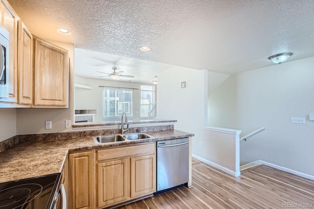 kitchen featuring stainless steel dishwasher, hardwood / wood-style floors, range, sink, and a textured ceiling