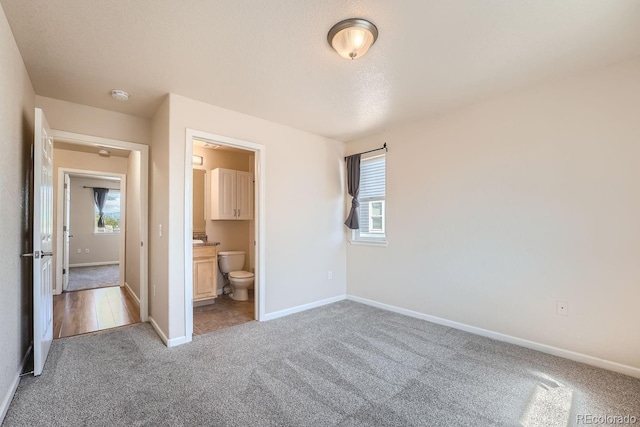 unfurnished bedroom featuring carpet floors and multiple windows