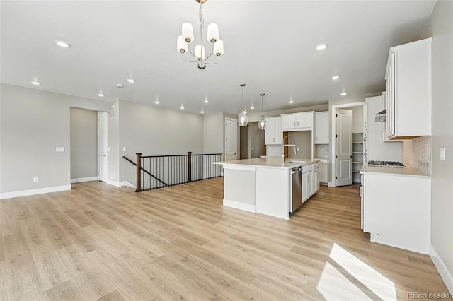 kitchen with recessed lighting, open floor plan, light wood-style flooring, stainless steel dishwasher, and a sink