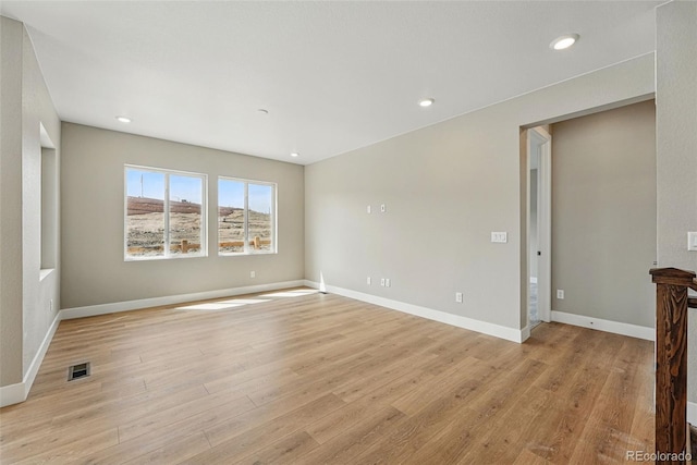 spare room featuring visible vents, baseboards, light wood-type flooring, and recessed lighting