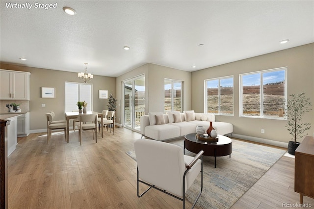 17196 W 92nd Loop, Arvada, CO 80007 - living room with a chandelier, light wood-style floors, baseboards, and recessed lighting